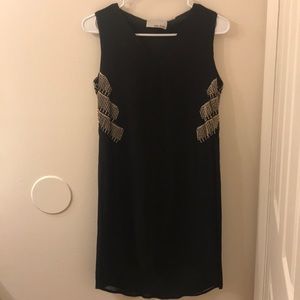 Black cocktail dress with cool detail.
